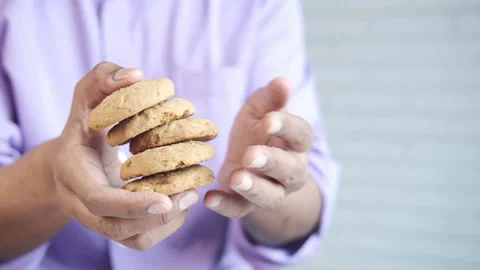 Hand holding stack of whole meal cookies with copy space Stock Footage 155156026