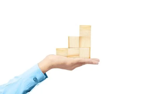 Hand holding stack of wooden block toy Stockfoto's