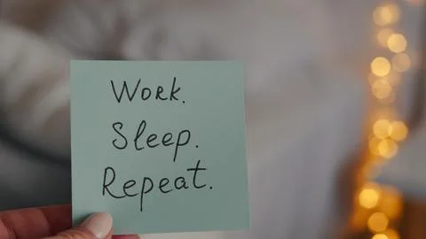 Hand holding sticky note with text about work-life balance and burnout Stock Photos
