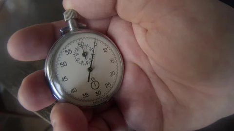 Hand holding a stopwatch Stock Footage 144678001