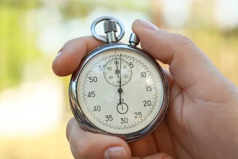 Hand holding a stopwatch showing zero seconds Stock Photos