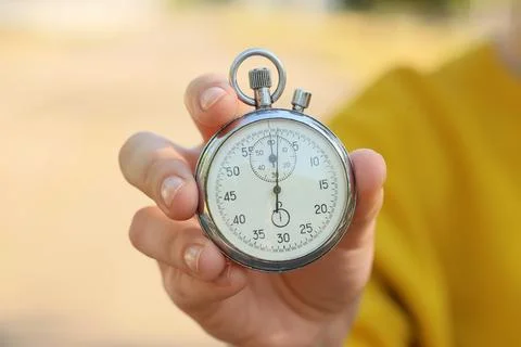 Hand holding a stopwatch showing zero seconds Stock Photos