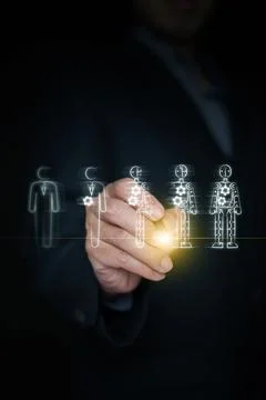 Hand holding stylus drawing progression from human worker to full robot. Ar.. Stock Photos