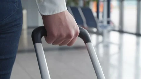 Hand holding a suitcase in close up Stock Footage 159890877