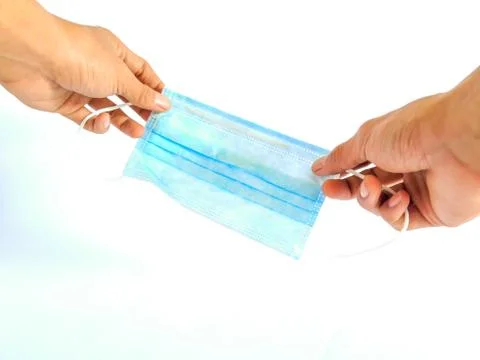 Hand holding surgical mask Stock Photos