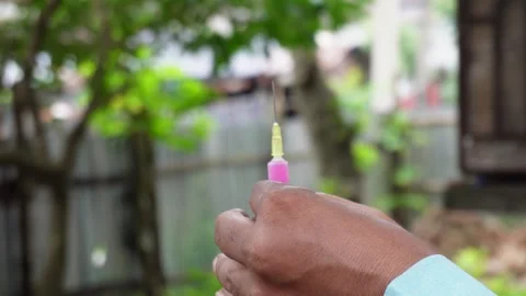 Hand Holding Syringe Filled Stock-Footage 328525869