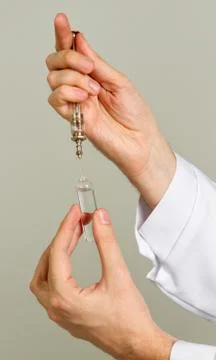 Hand holding a syringe Stock Photos