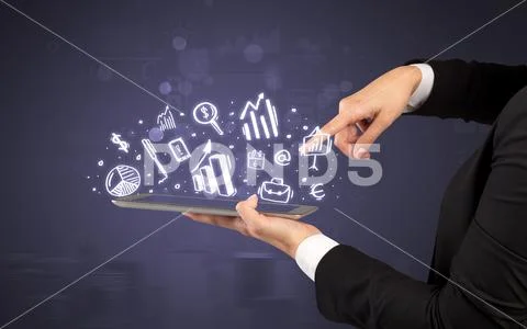 Hand holding tablet with chalk drawn symbols above Stock Photos
