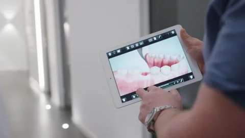 Hand Holding Tablet with Dental Teeth Visualization, Modern Clinic, Close Up Stock Footage 341574528