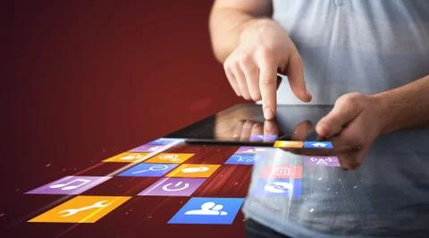 Hand holding tablet device with media application Stock Photos