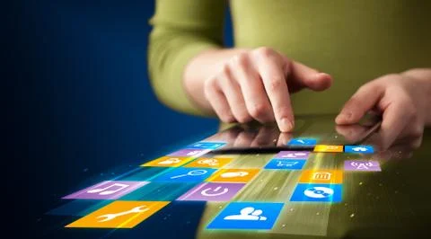 Hand holding tablet device with media application Stock Photos