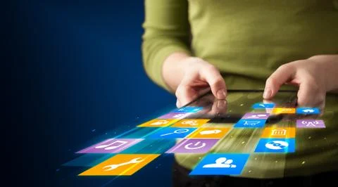 Hand holding tablet device with media application Stock Photos