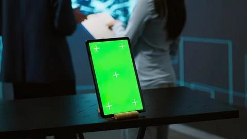 Hand holding tablet with green screen Stock Photos