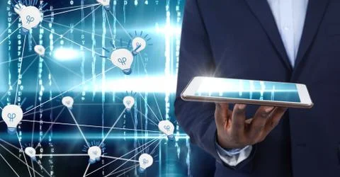 Hand holding tablet with light bulb icons in technology background Foto stock