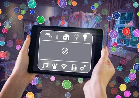 Hand holding tablet with smart home interface and connectors 스톡 사진