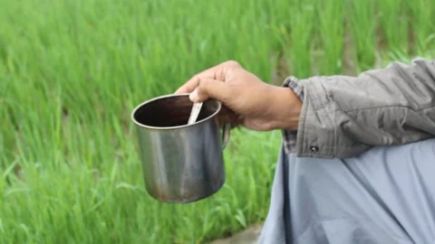 Hand holding teacup Stock Footage 243894015