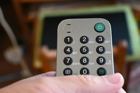 Hand holding a television remote control Stock Photos