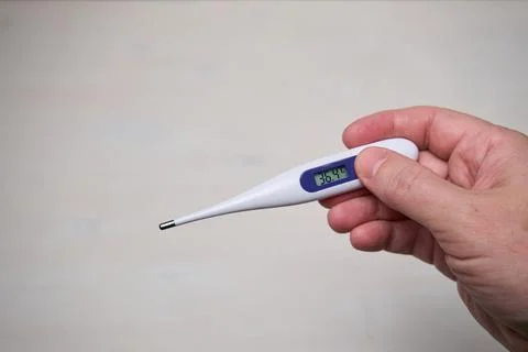 Hand holding thermometer Stock Photos