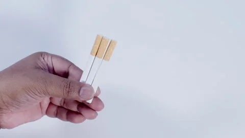 A Hand Holding three Cigarettes Stock Footage 248760255
