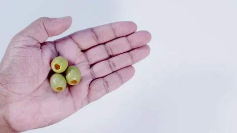 Hand Holding Three Green Olives Stock Footage 248760503