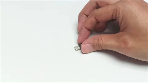 Hand holding tiny black micro usb adapter connector close up Stock Footage 340860926