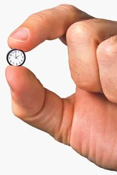 Hand holding tiny clock Stock Photos