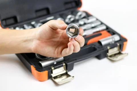 The hand holding the tool. Tool kit for the car. Isolated on white background Stock-Fotos