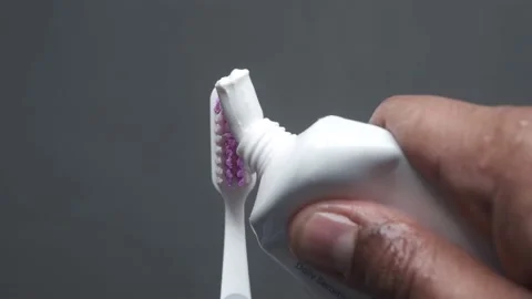 Hand holding tooth brush with paste Stock Footage 170891371