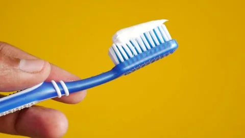 Hand holding tooth brush with paste Stock Footage 227899291