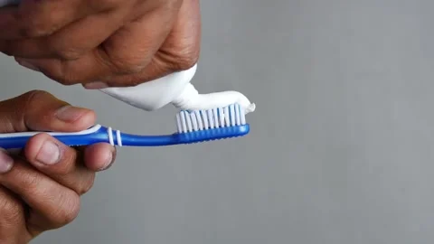 Hand holding tooth brush with paste Stock Footage 228447250