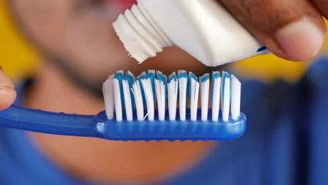 Hand holding tooth brush with paste Stock Footage 228680782