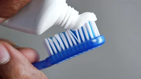 Hand holding tooth brush with paste Stock Footage 231276562
