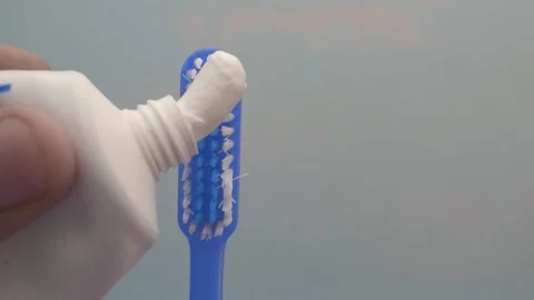Hand holding tooth brush with paste Stock Footage 236325243
