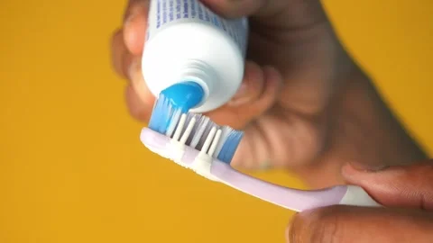 Hand holding tooth brush with paste Stock Footage 273437212