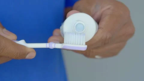 Hand holding tooth brush with paste Stock Footage 277474677