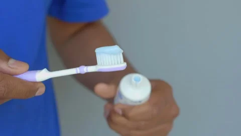 Hand holding tooth brush with paste Stock Footage 281542428