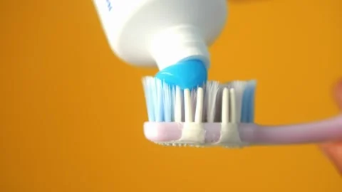 Hand holding tooth brush with paste Stock Footage 282077459