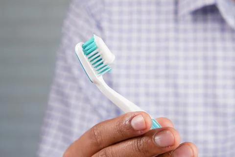 Hand holding tooth brush with paste Stock Photos