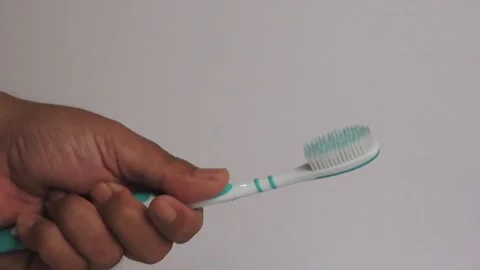 Hand Holding a Toothbrush with Focus on Hand Grip Stock Footage 304257657