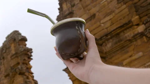Hand holding traditional mate cup at San Ignacio ruins in Misiones, Argentina. Stock Footage 331463947