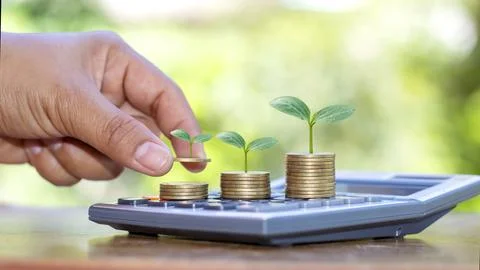 The hand holding the tree that grows on the coin includes the sapling, the .. Stock Photos