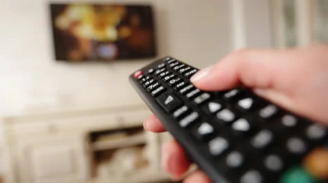 Hand holding TV remote control and changing channels on television Video stock 61510774