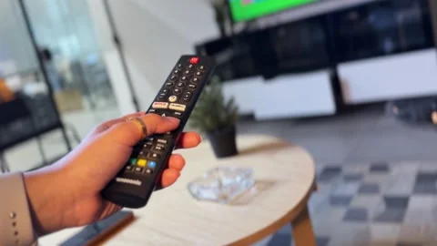 Hand Holding TV Remote Control Stock Footage 338035007