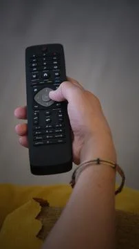 Hand holding tv remote control Stock Photos