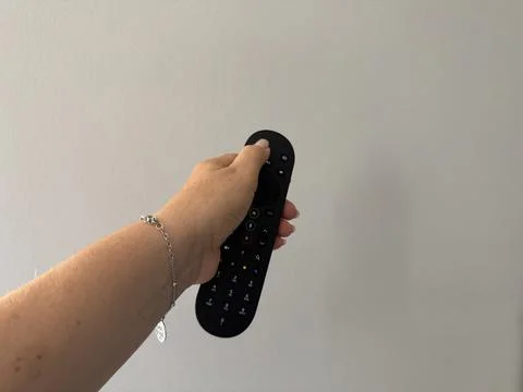 Hand holding a TV remote control Stock Photos