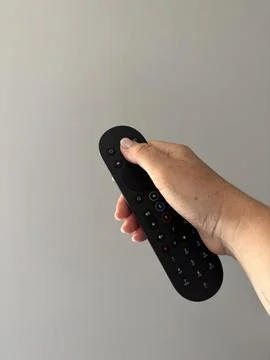 Hand holding a TV remote control Stock Photos