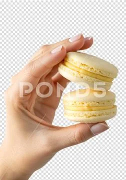 Hand holding two delicate french macarons with smooth yellow lemon cream filling Modello PSD