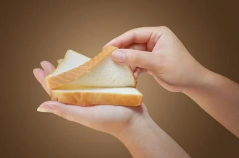 Hand holding two slices of bread Stock Photos