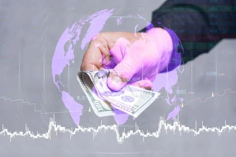 Hand holding US dollar banknotes against a global map with stock market cha.. Stock Photos