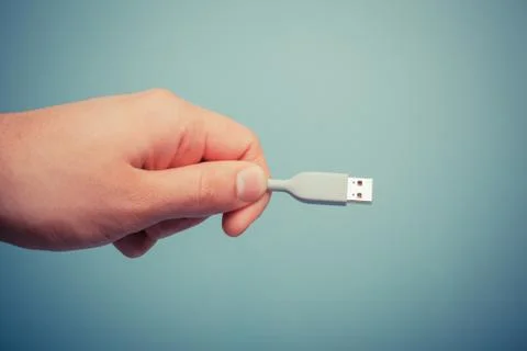 Hand holding usb cable 写真素材